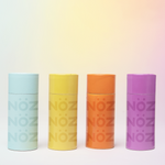 Load image into Gallery viewer, Neon blue, yellow, orange, and purple Nöz sunscreen sticks with pale gradient background reflecting the neon colors. 
