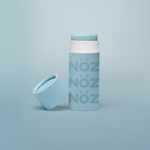 Load image into Gallery viewer, Blue Nöz sunscreen stick with cap off, tilted against base of stick. All against a pale blue gradient background. 
